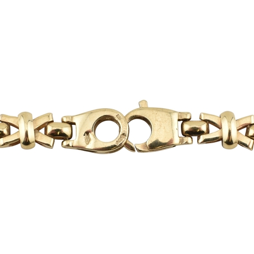 109 - A hallmarked 9ct gold fancy link chain necklace. The necklace is formed with fancy cross links to a ... 