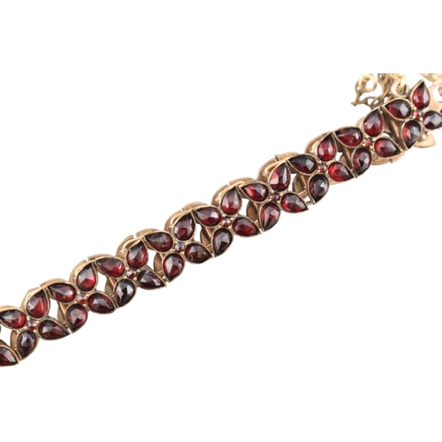117 - An early 20th century Bohemian garnet bracelet with a hallmarked 9ct gold padlock clasp. The clasp i... 