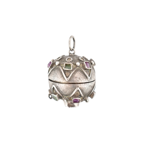 119 - A French silver gem set orb locket pendant. The orb set with multicoloured foil back gems to a textu... 