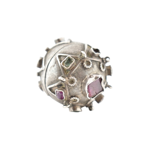 119 - A French silver gem set orb locket pendant. The orb set with multicoloured foil back gems to a textu... 