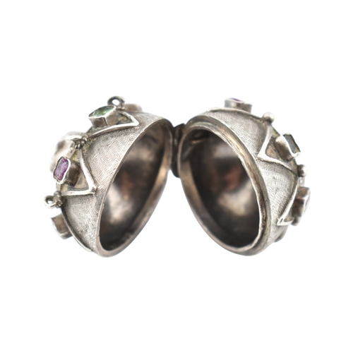 119 - A French silver gem set orb locket pendant. The orb set with multicoloured foil back gems to a textu... 