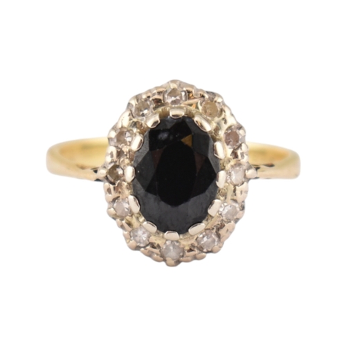 181 - A hallmarked 18ct gold sapphire and diamond cluster ring. Hallmarked London. Weight 3.1g. Size L.5.... 