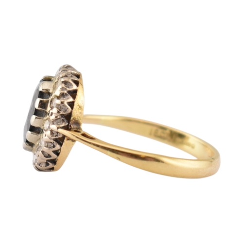 181 - A hallmarked 18ct gold sapphire and diamond cluster ring. Hallmarked London. Weight 3.1g. Size L.5.... 