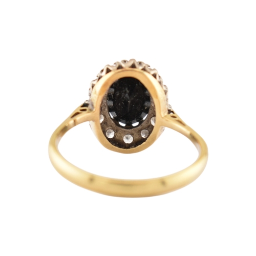 181 - A hallmarked 18ct gold sapphire and diamond cluster ring. Hallmarked London. Weight 3.1g. Size L.5.... 