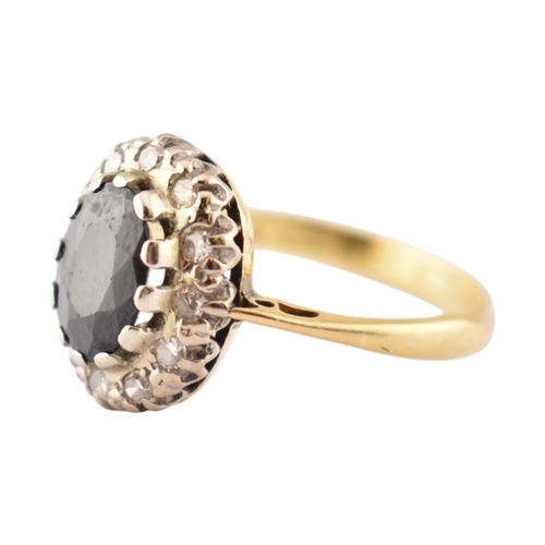 181 - A hallmarked 18ct gold sapphire and diamond cluster ring. Hallmarked London. Weight 3.1g. Size L.5.... 