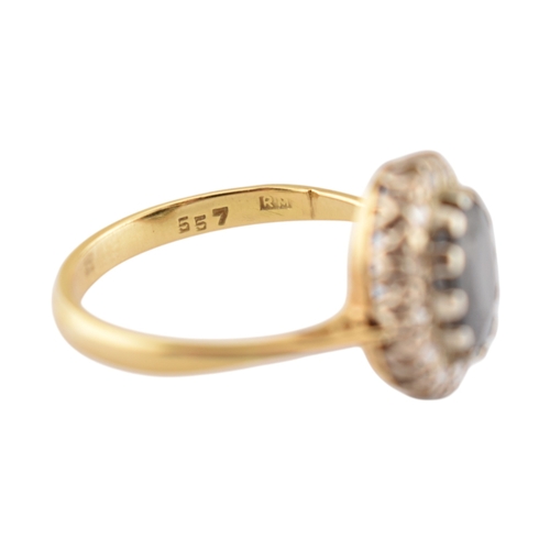 181 - A hallmarked 18ct gold sapphire and diamond cluster ring. Hallmarked London. Weight 3.1g. Size L.5.... 