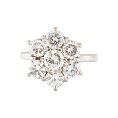 192 - An 18ct gold and diamond cluster ring. The ring set with seven round brilliant cut diamonds. Princip... 