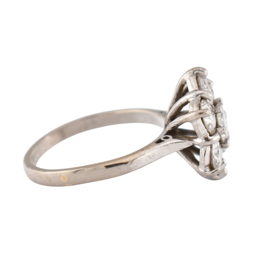 192 - An 18ct gold and diamond cluster ring. The ring set with seven round brilliant cut diamonds. Princip... 