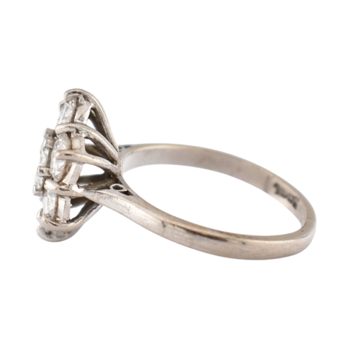 192 - An 18ct gold and diamond cluster ring. The ring set with seven round brilliant cut diamonds. Princip... 