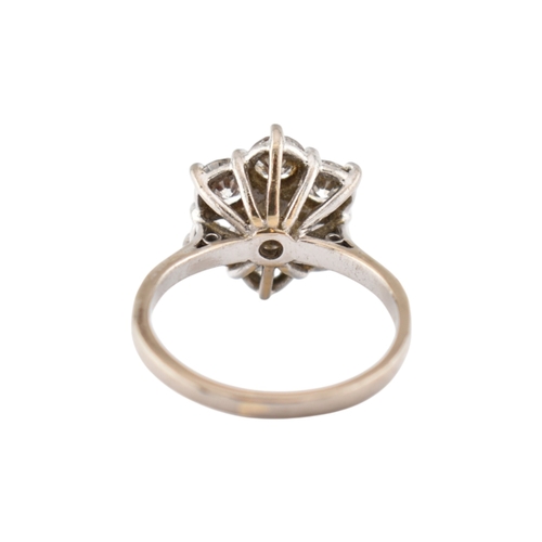 192 - An 18ct gold and diamond cluster ring. The ring set with seven round brilliant cut diamonds. Princip... 