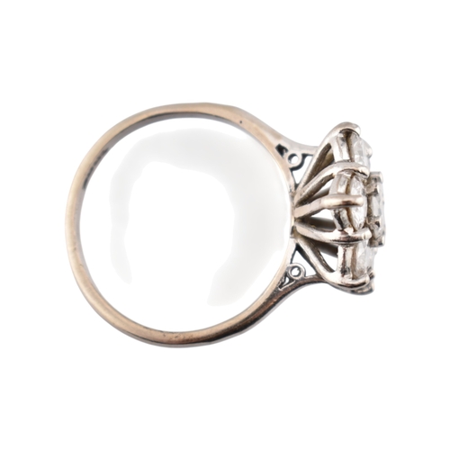 192 - An 18ct gold and diamond cluster ring. The ring set with seven round brilliant cut diamonds. Princip... 