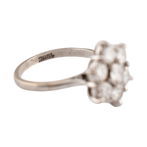 192 - An 18ct gold and diamond cluster ring. The ring set with seven round brilliant cut diamonds. Princip... 