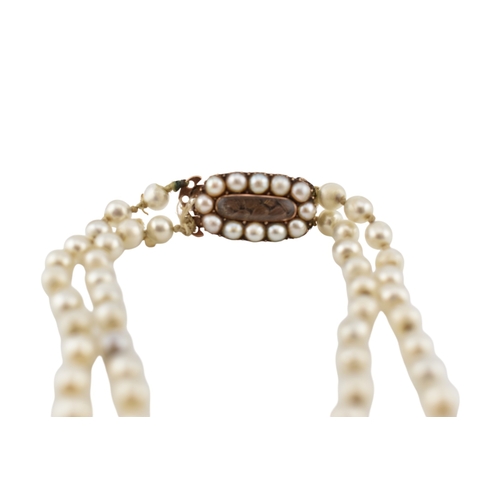 194 - A 19th century simulated glass pearl necklace with a mourning hair locket clasp. The clasp having a ... 