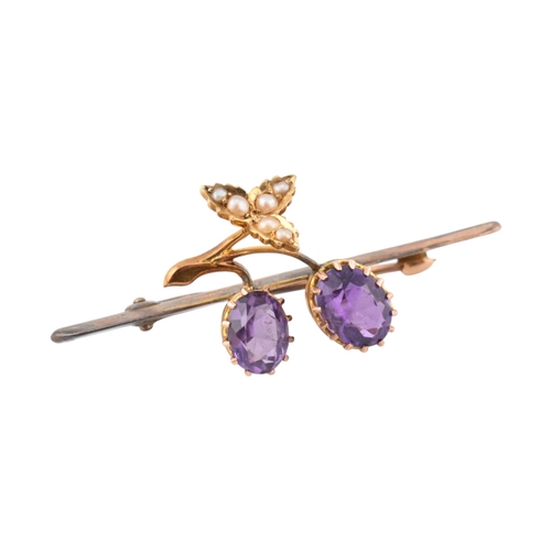 197 - An early 20th century Amethyst and pearl brooch pin. The brooch in the form of a fruiting vine set w... 