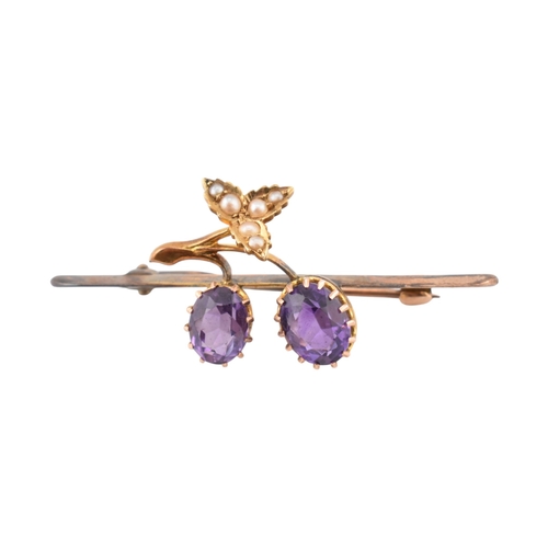 197 - An early 20th century Amethyst and pearl brooch pin. The brooch in the form of a fruiting vine set w... 