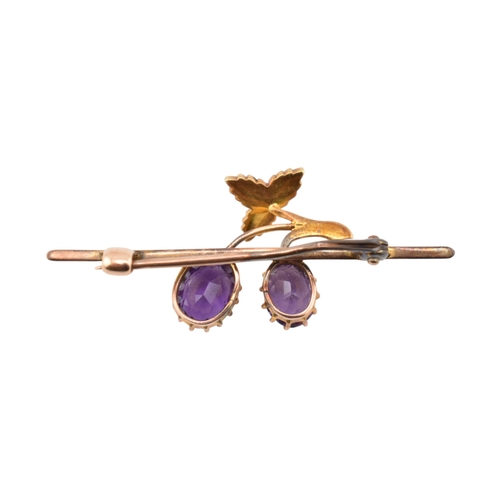 197 - An early 20th century Amethyst and pearl brooch pin. The brooch in the form of a fruiting vine set w... 