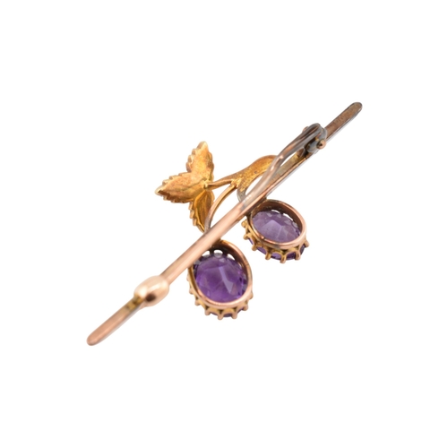 197 - An early 20th century Amethyst and pearl brooch pin. The brooch in the form of a fruiting vine set w... 