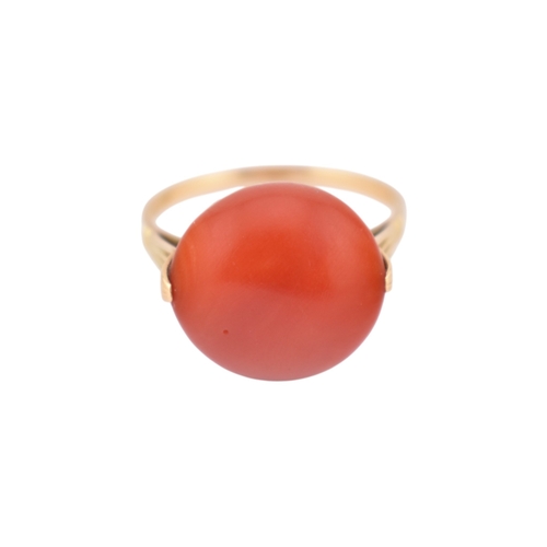 203 - An Art Deco 14ct gold & and coral cabochon ring. The ring set with a large round coral cabochon ... 