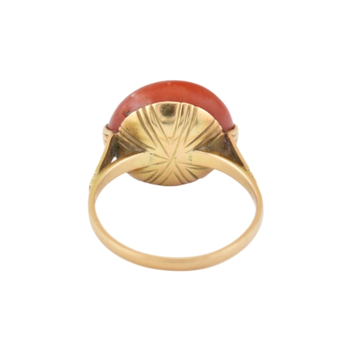 203 - An Art Deco 14ct gold & and coral cabochon ring. The ring set with a large round coral cabochon ... 