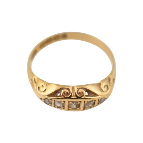 208 - An early 20th century hallmarked 18ct gold & diamond five stone boat ring. The ring set with fiv... 