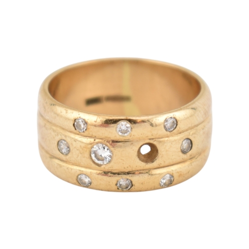 214 - A hallmarked 9ct gold and diamond wide ribbed band ring. Weight 8.7g. Size Q. One diamond deficient.... 