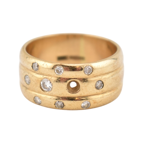 214 - A hallmarked 9ct gold and diamond wide ribbed band ring. Weight 8.7g. Size Q. One diamond deficient.... 