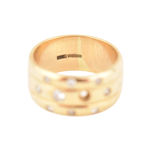 214 - A hallmarked 9ct gold and diamond wide ribbed band ring. Weight 8.7g. Size Q. One diamond deficient.... 