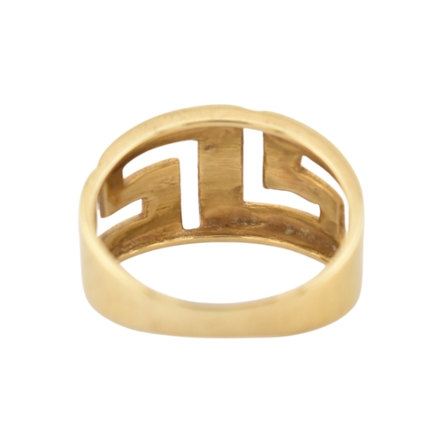 216 - An 18ct gold band ring. The ring with pierced Greek key decoration. Stamped 750. Weight 5.9g. Size R... 