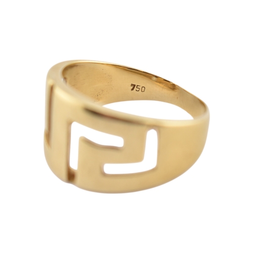 216 - An 18ct gold band ring. The ring with pierced Greek key decoration. Stamped 750. Weight 5.9g. Size R... 
