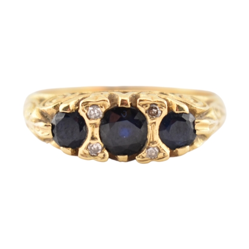 222 - An 18ct gold sapphire and diamond three stone ring. Stamped 18ct. Weight 4.8g. Size P