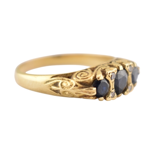 222 - An 18ct gold sapphire and diamond three stone ring. Stamped 18ct. Weight 4.8g. Size P