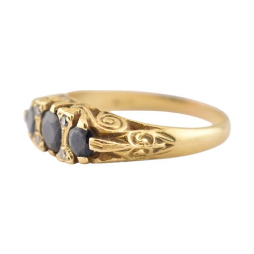 222 - An 18ct gold sapphire and diamond three stone ring. Stamped 18ct. Weight 4.8g. Size P