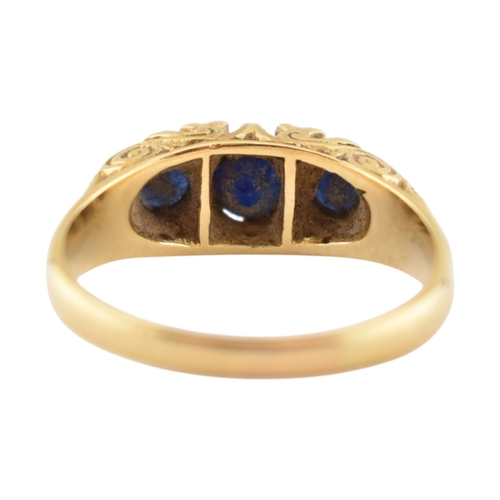 222 - An 18ct gold sapphire and diamond three stone ring. Stamped 18ct. Weight 4.8g. Size P