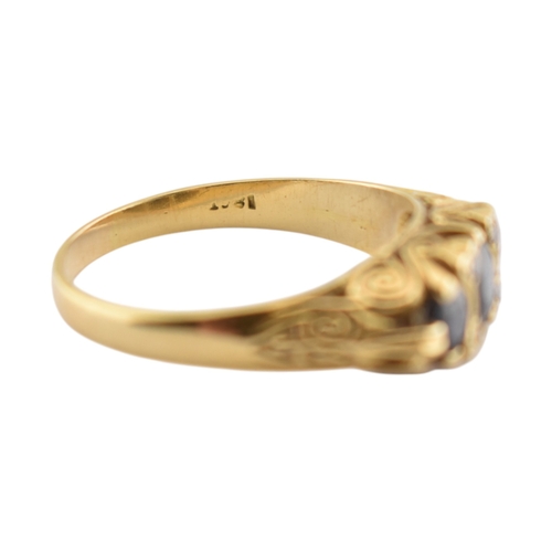 222 - An 18ct gold sapphire and diamond three stone ring. Stamped 18ct. Weight 4.8g. Size P