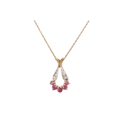224 - A hallmarked 9ct gold ruby and diamond pendant necklace. The pendant hallmarked 9ct, the chain stamp... 