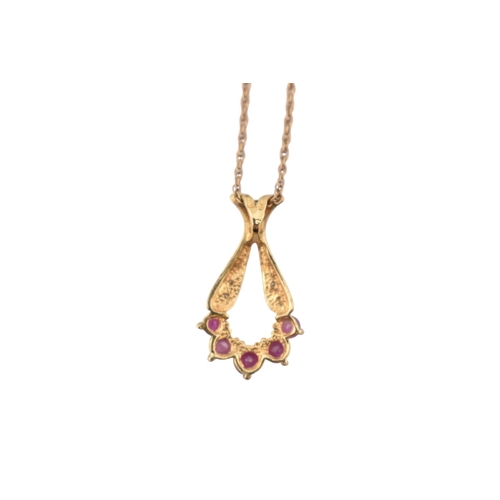 224 - A hallmarked 9ct gold ruby and diamond pendant necklace. The pendant hallmarked 9ct, the chain stamp... 