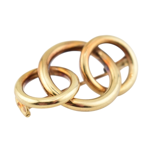 225 - A retro 14ct gold Knot brooch pin. The brooch with three entwined concentric circles to a trombone c... 