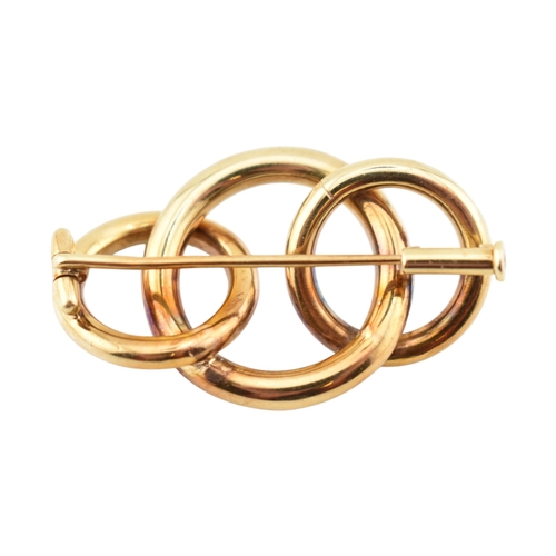225 - A retro 14ct gold Knot brooch pin. The brooch with three entwined concentric circles to a trombone c... 