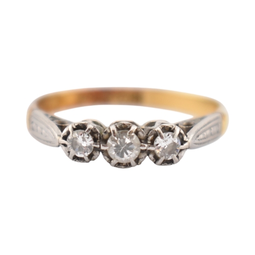 229 - An 18ct gold and platinum three stone diamond ring. Stamped 18ct & Plat. Weight 1.8g. Size K... 