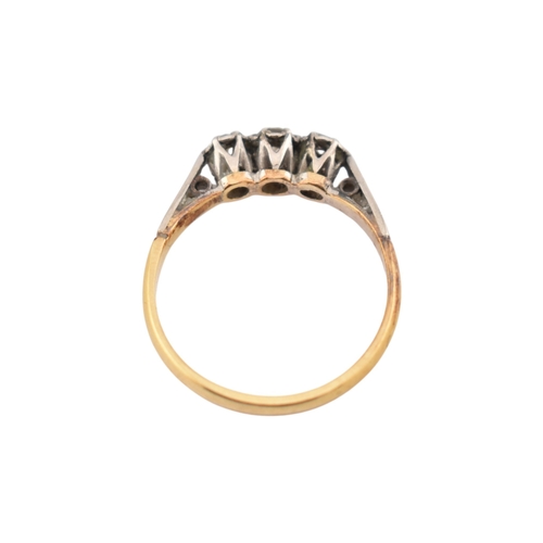229 - An 18ct gold and platinum three stone diamond ring. Stamped 18ct & Plat. Weight 1.8g. Size K... 