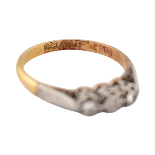 229 - An 18ct gold and platinum three stone diamond ring. Stamped 18ct & Plat. Weight 1.8g. Size K... 