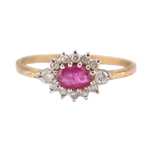 239 - A hallmarked 9ct gold ruby and diamond halo ring. Weight 1.9g. Size U