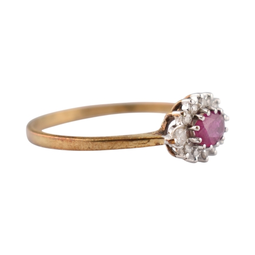 239 - A hallmarked 9ct gold ruby and diamond halo ring. Weight 1.9g. Size U