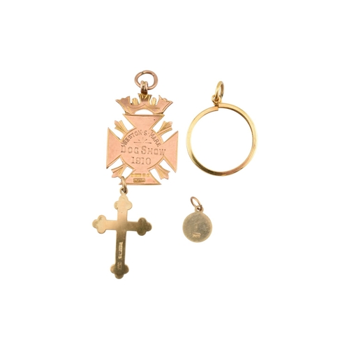 314 - A collection of 9ct gold pendants. To include an armorial medal pendant marked for Weston Super Mare... 