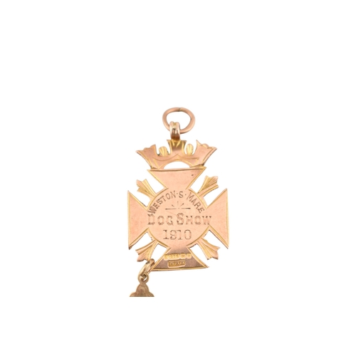 314 - A collection of 9ct gold pendants. To include an armorial medal pendant marked for Weston Super Mare... 