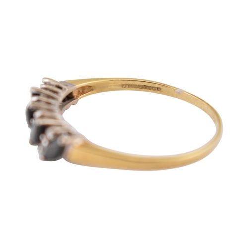 320 - A hallmarked 18ct gold sapphire and diamond five stone ring. Weight 2.6g. Size V