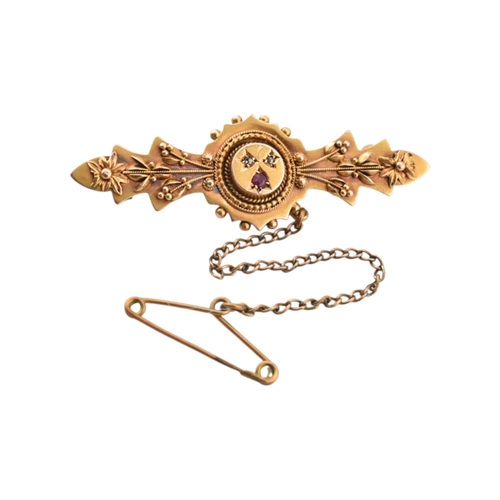 327 - A Victorian 15ct gold Ruby and diamond brooch pin with filigree decoration. Stamped 15ct. Pin metal.... 