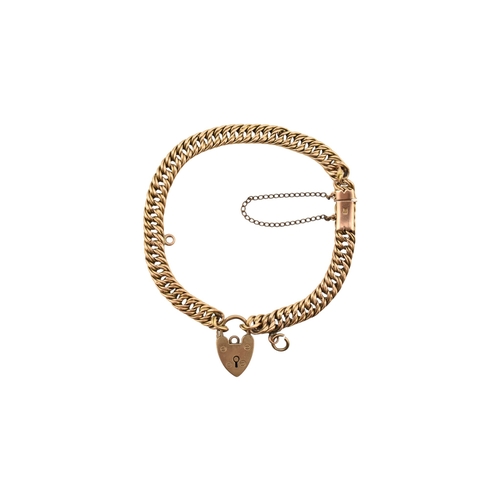 335 - A 15ct gold fancy link bracelet adorned with a 9ct gold hallmarked heart padlock. Stamped 15ct to br... 