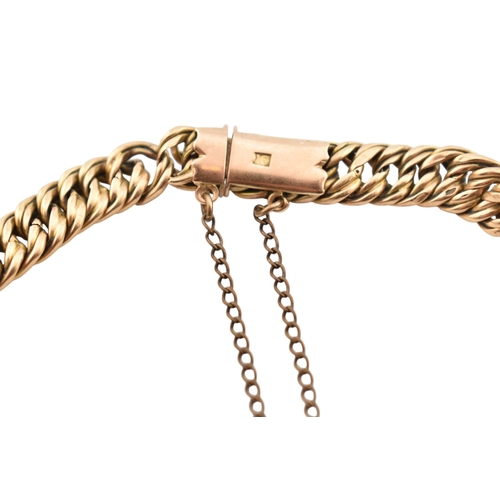 335 - A 15ct gold fancy link bracelet adorned with a 9ct gold hallmarked heart padlock. Stamped 15ct to br... 