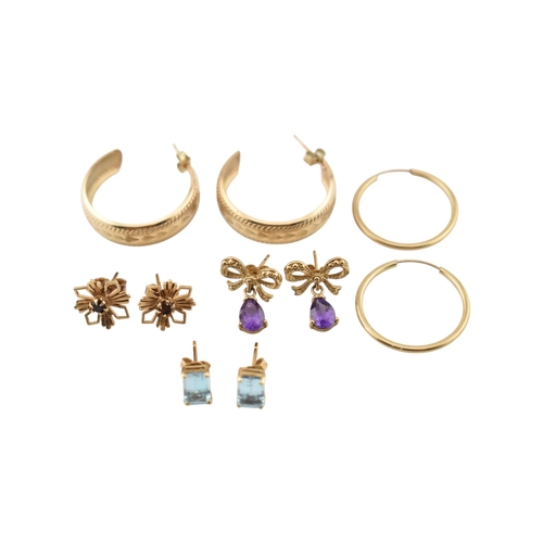 338 - A collection of 9ct gold and gem set earrings. The earrings to include hoops, amethyst, bow pendant ... 